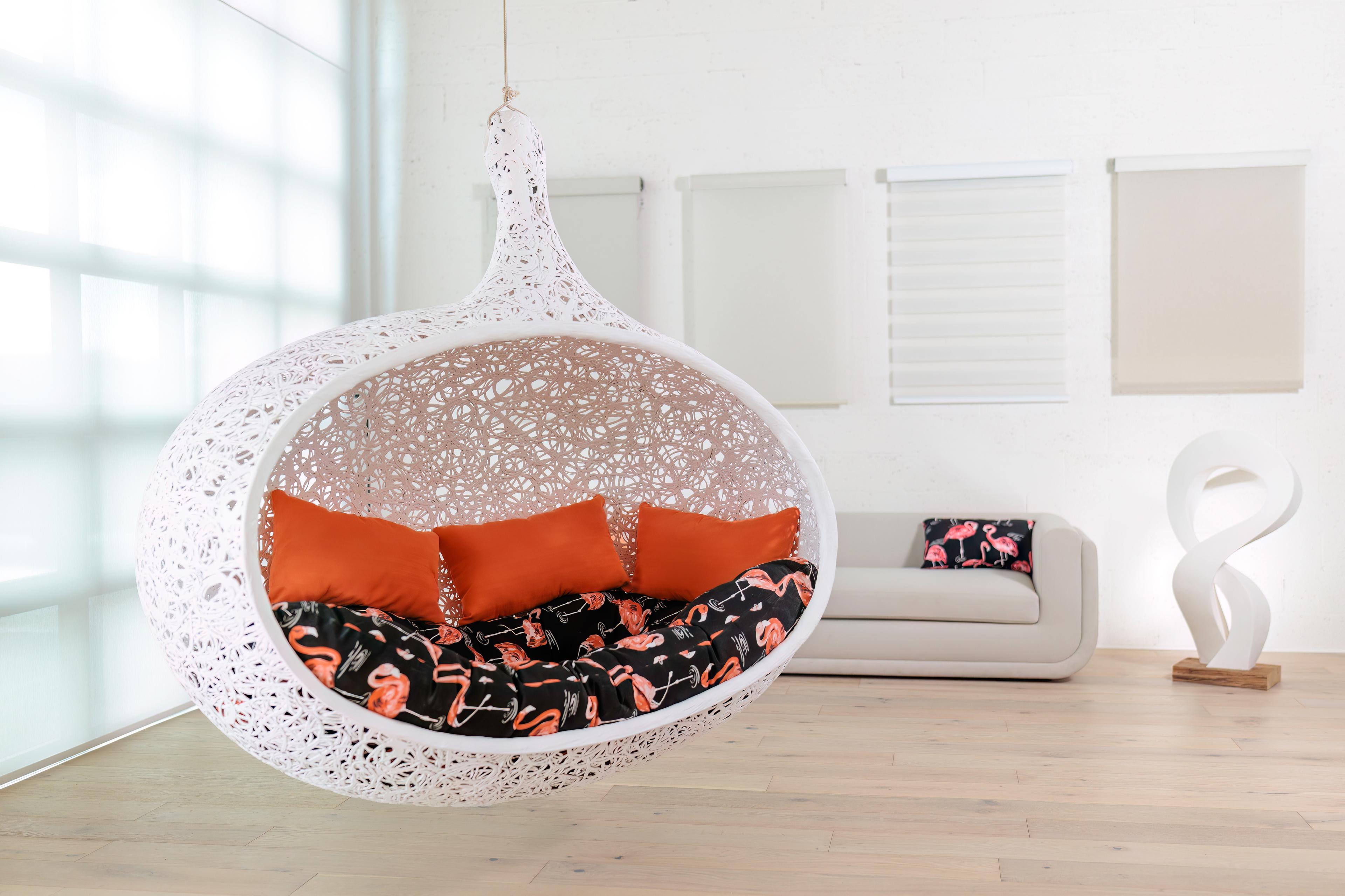 Lavanest Cocoon — white hanging basalt fiber chair with cushions on display